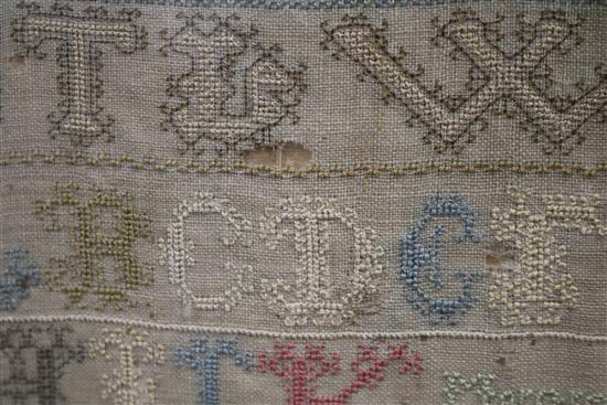 An early 19th century needlework sampler with alphabet, houses, lion, flowers and other motifs, dated 1805, 41 x 31.5cm